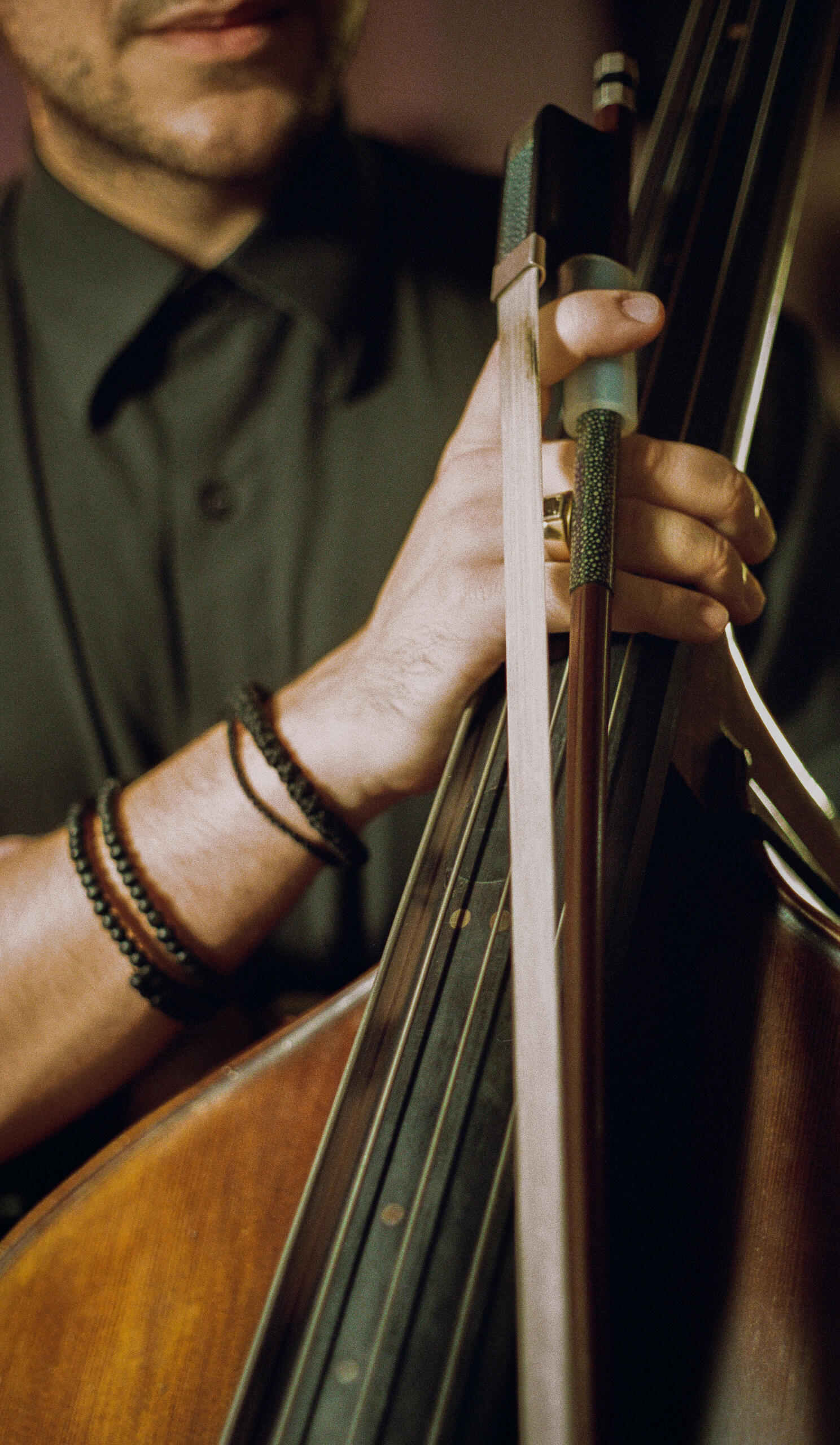 Elias Kokkoris holding his double bass and a handmade Boris Fritsch bow, recording with the Callum Pask Trio at Alchemix Studios, West End, Brisbane. Photo by Luis Campbell.